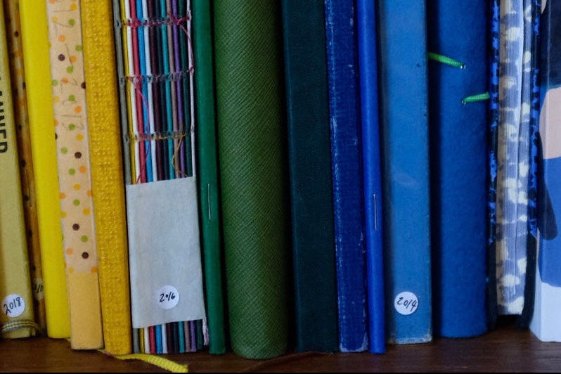 Row of colorful books with various patterns on a shelf