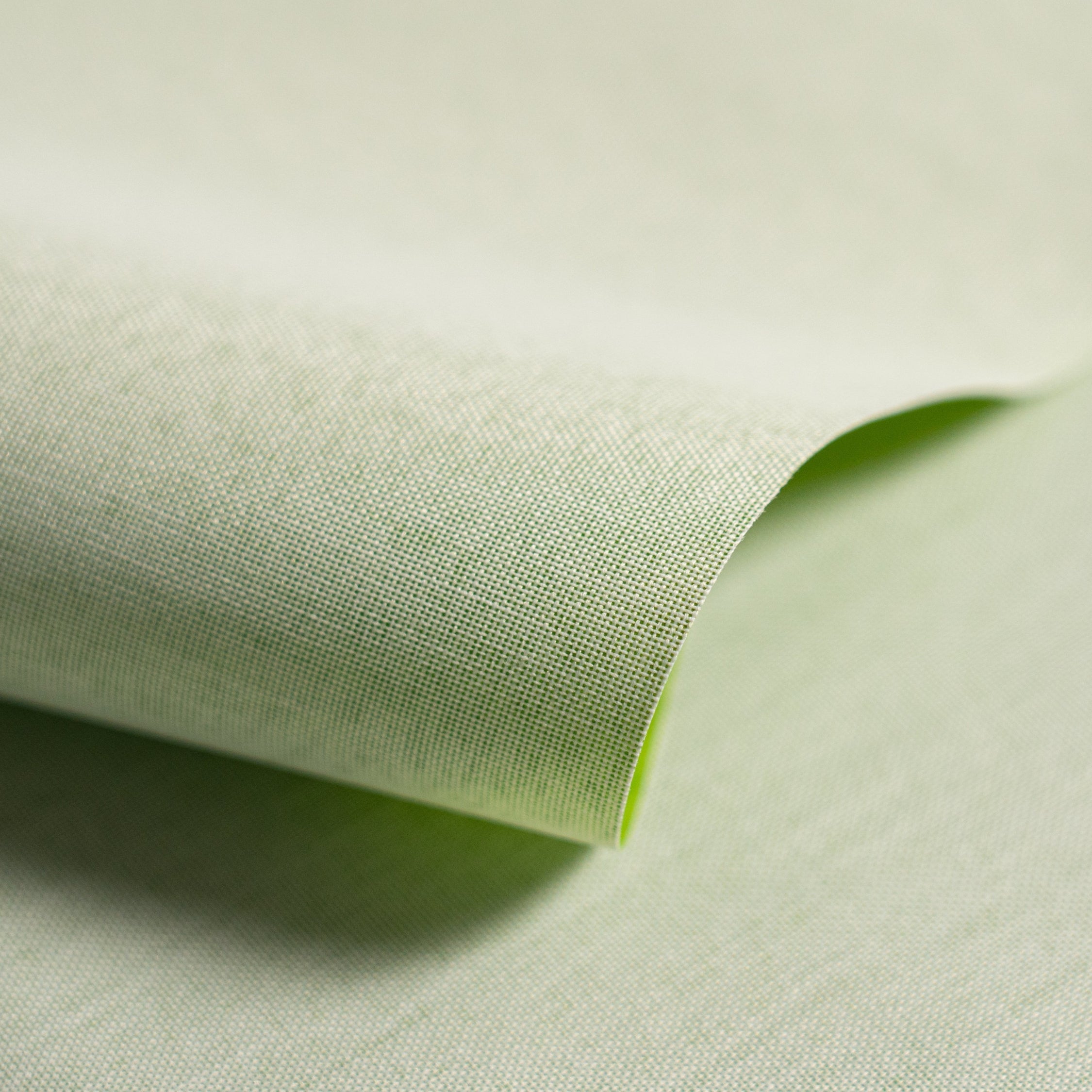 Close-up of light green fabric with a slight texture