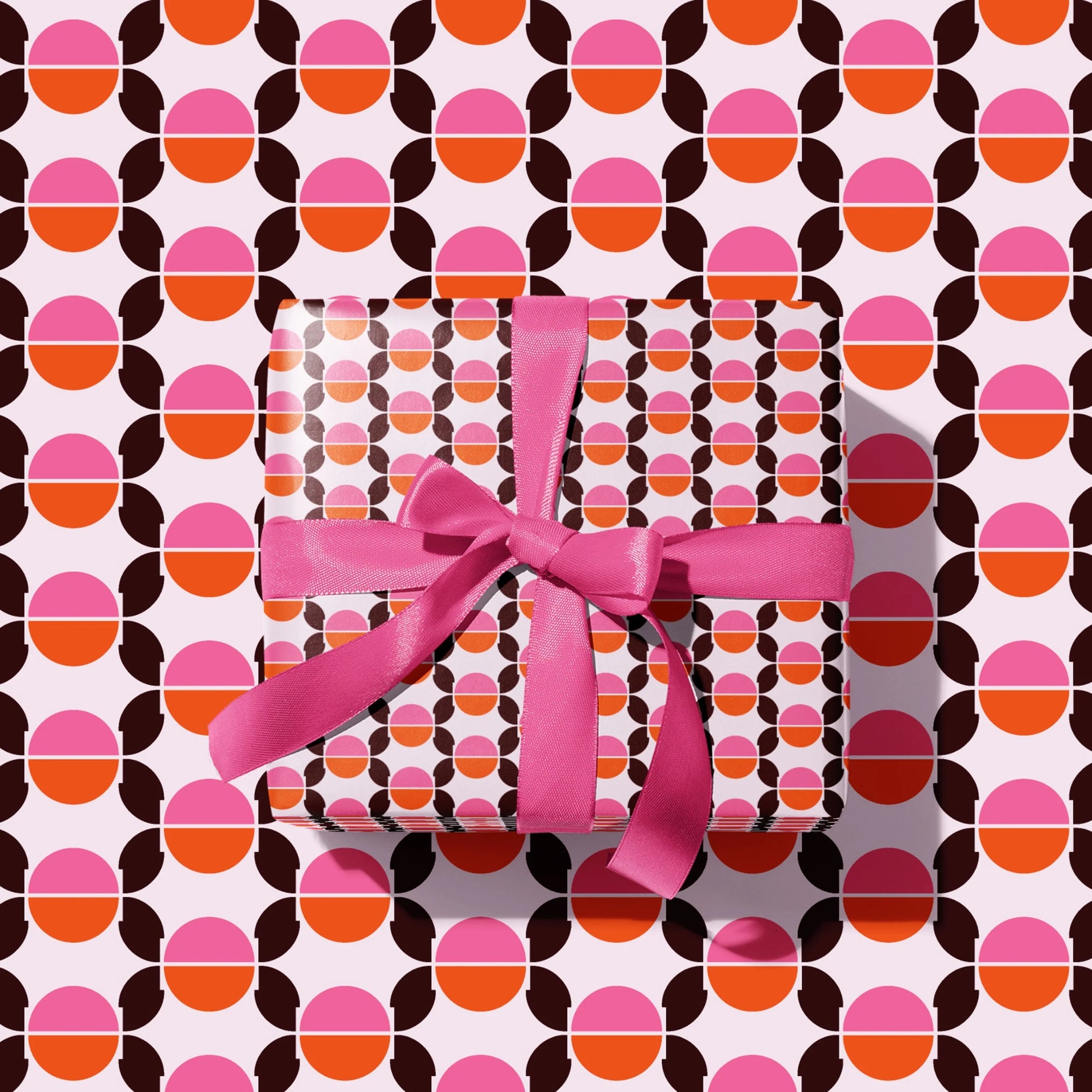 Seventies Wrapping Paper with geometric circular design and retro pink, orange and brown colours. 
