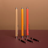 Set of colorful pens on a brown surface with a brown background
