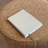 Small notebook on a textured brown surface