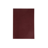 Burgundy pocket sized notebook on a white background