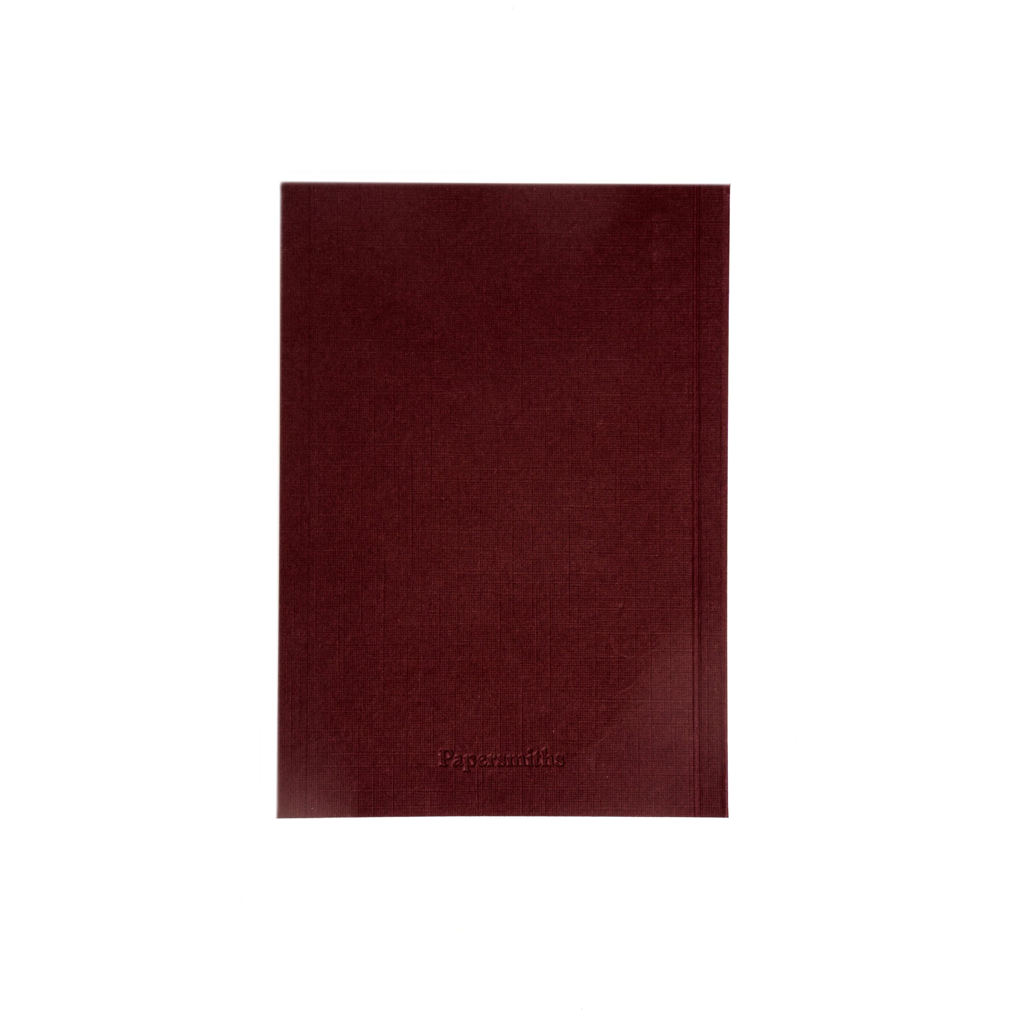 Burgundy pocket sized notebook on a white background
