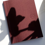 Burgundy pocket notebook with Papersmiths log on white background