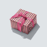 Seventies Wrapping Paper with geometric circular design and retro pink, orange and brown colours. 