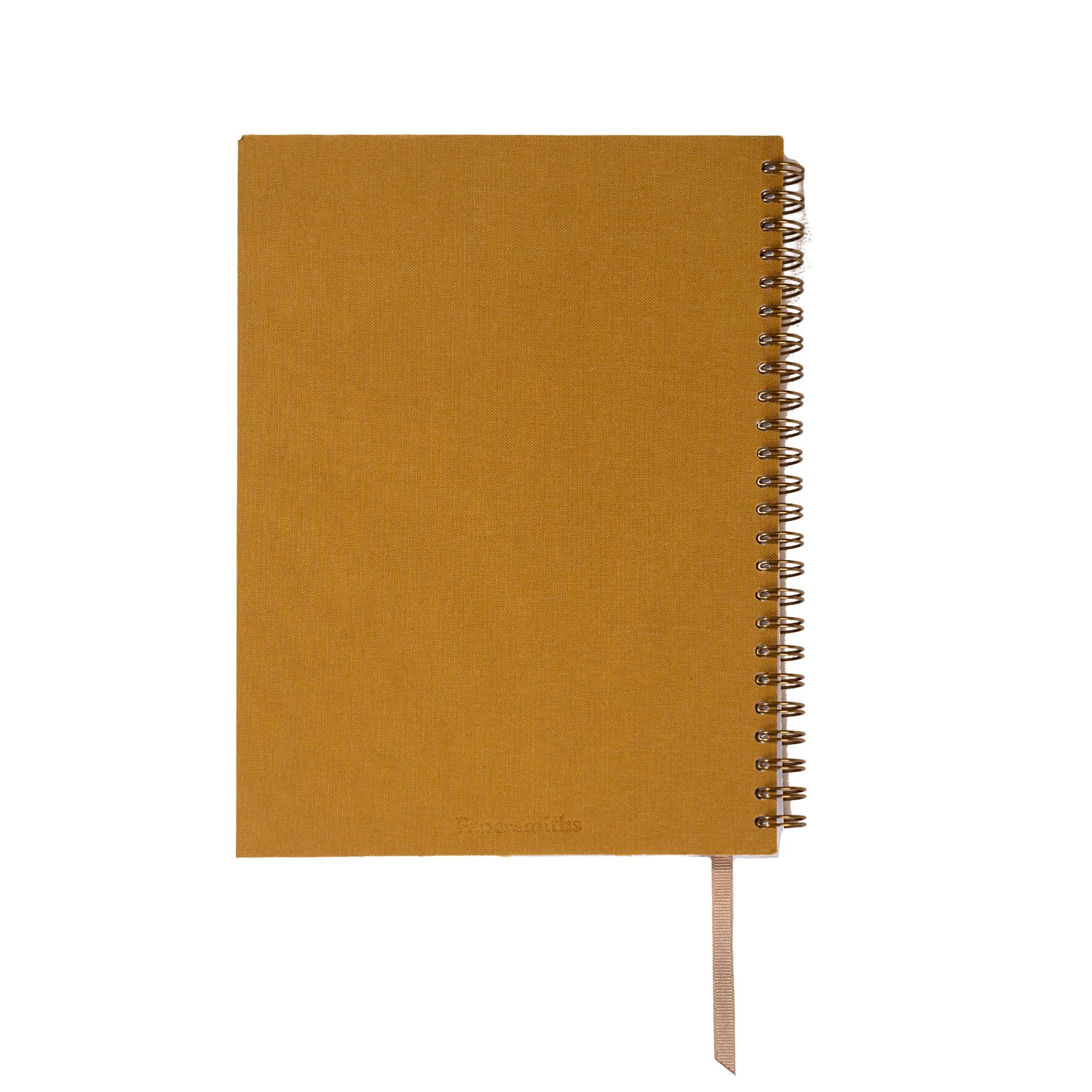 Mustard yellow notebook with a spiral binding on a white background