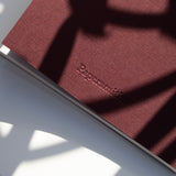 Burgundy pocket notebook with Papersmiths logo