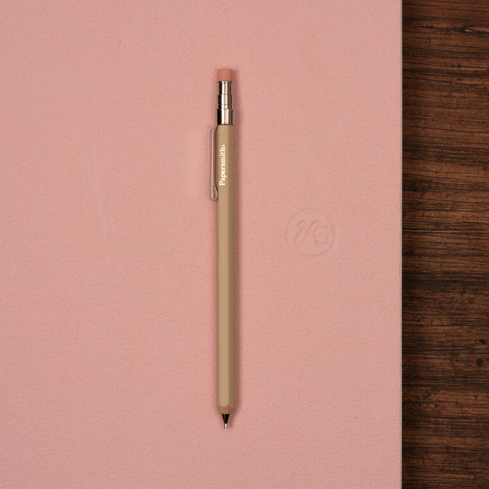 Beige pocket pencil on pink notebook
