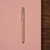 Beige pocket pencil on pink notebook