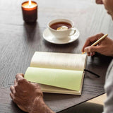 The Three Question Journal in Oat. A prompted for journal writing with a linen cover. 