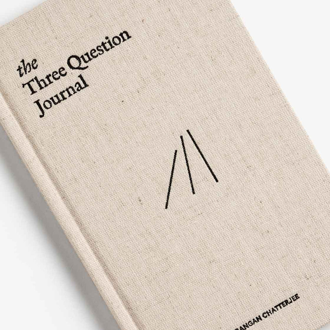 Close up of the the Three Question Journal in Oat. A prompted for journal writing with a linen cover. 