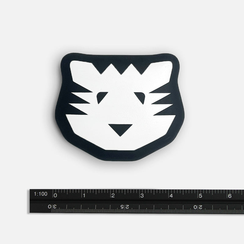 Black and white tiger face design on a white background with a ruler for scale.